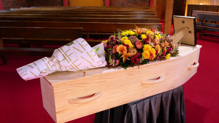 closeup shot of a colorful casket in a hearse or chapel before funeral or burial at cemetery