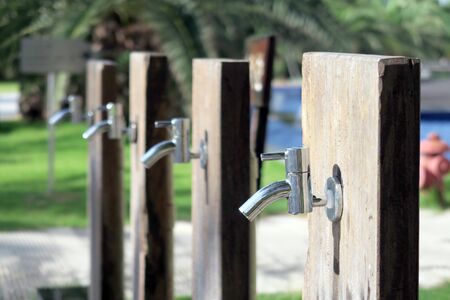 Flushing taps outside beachfront hotelの写真素材