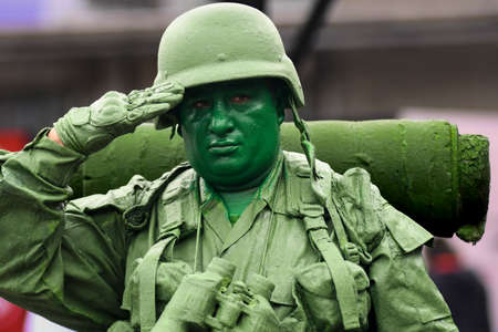 Military man salutes in the foregroundのeditorial素材