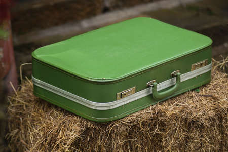 Antique green leather suitcase foreground