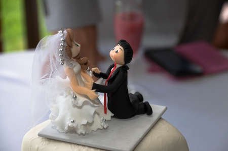 Kneeling wedding cake figurines in the foregroundの写真素材