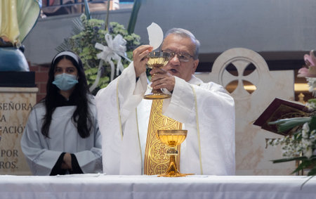 Bogota Colombia December 3, 2022 Catholic priest prays during a religious ceremonyのeditorial素材