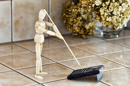 Wooden Ball-jointed doll using calculator.の写真素材