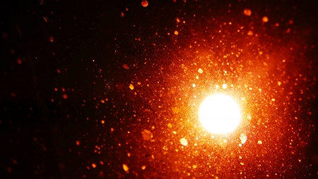 Golden burst of glowing particles resembling dust or glitter but actually water spots on a window...
