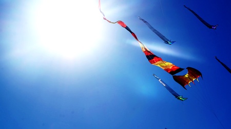 Kites Sailing in the Bright Blue Summer Sky During the Beach Kiting Party in Huntington Beach, California 2013の写真素材