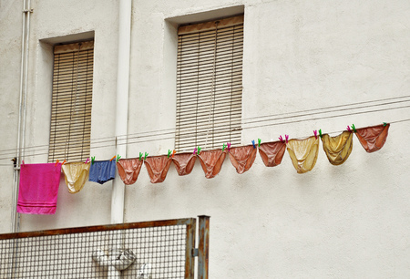 many panties drying on a rope outdoorsの写真素材