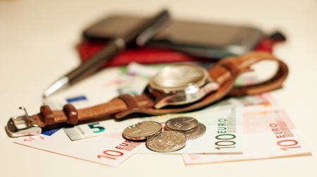 clock, phone, money, pen on a white の写真素材