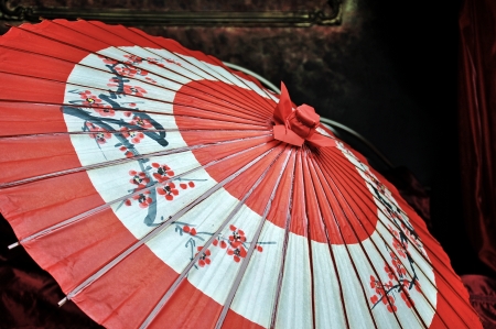 Traditional Japanese umbrella lies on a beautiful bedの写真素材