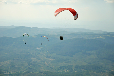 three paragliders flying over the mountains in Spainのeditorial素材