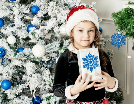 girl in the bell of Santa Claus holding a presentの写真素材