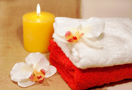 two towels for spa with sea shell, orchid and candlesの写真素材