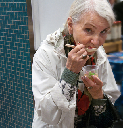 very elderly woman eatsの写真素材