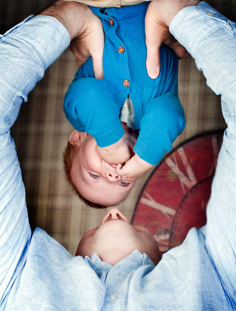 father playing with his son at home