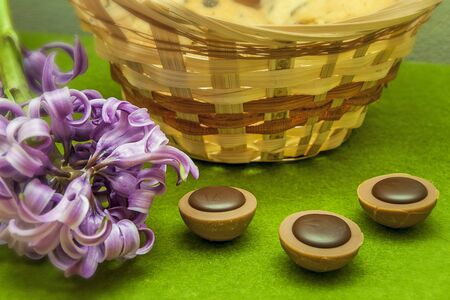 hyacinth, cookies, candy and wicker basket on a green backgroundの写真素材