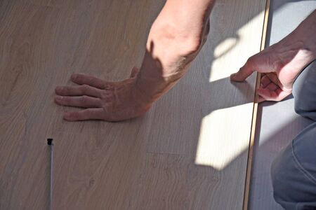 hammer on the wooden floor repaired in the bathroomの写真素材