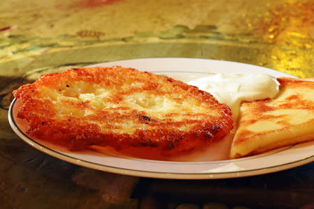 delicious pancakes with sour cream on wooden tableの写真素材