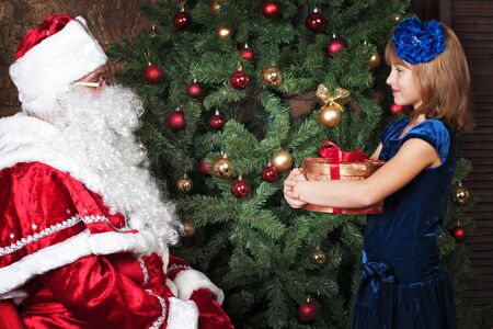 happy girl receives a gift from Santa Clausの写真素材