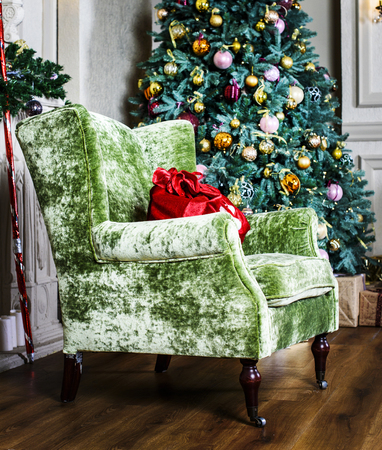 beautiful chair and Christmas tree with giftsの写真素材