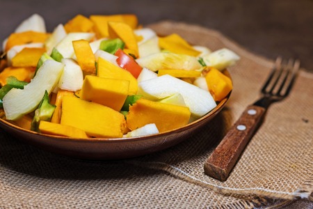 Fresh vegetables (squash, pumpkin, tomatoes, pepper..) cut for cooking. Vegetarian dish.の写真素材