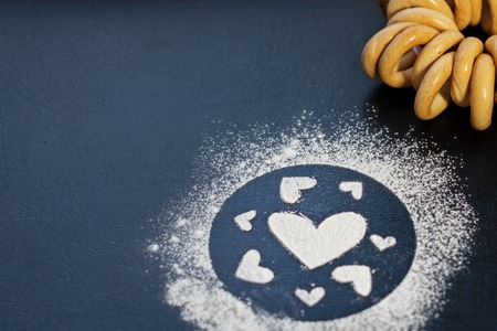 Concept Of Valentine's Day. Picture of heart of flour on a black background. Happy Valentines Day background.の写真素材