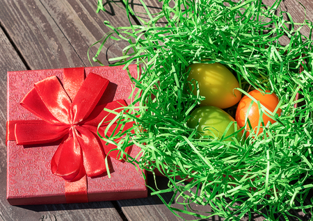 Easter colored eggs in the basket. Bright card. The concept of the Easter holiday.