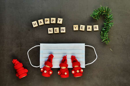 Protective medical mask. The inscription happy new year. Red toy men. The concept of gratitude and...