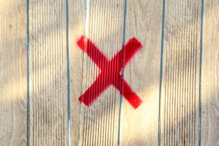 A No-sit sign on a wooden bench to ensure social distance between people during the Covid-19...