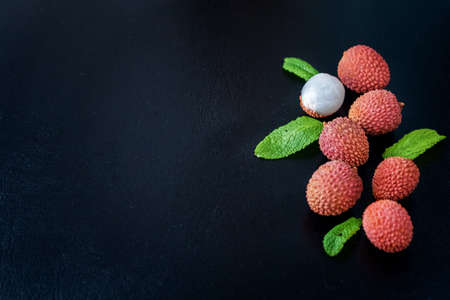 Fresh lychee fruit on black background, top view photo, copy space for text.の写真素材
