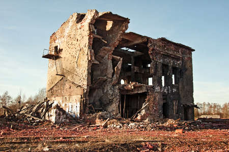 Landscape of ruined buildings at sunset, image of decrepitude or natural disasterの写真素材