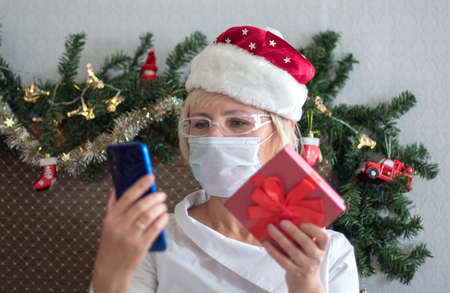 Christmas online congratulations. Smiling woman using mobile tablet for video call friends and...