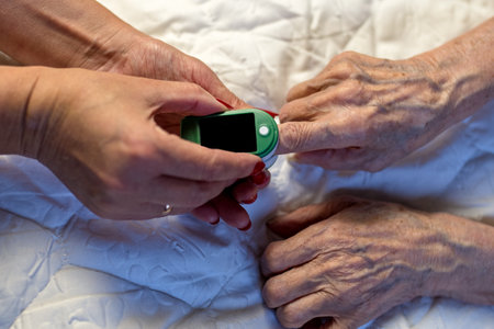 Assessment of the respiratory system function. measurement of blood saturation and pulse in an elderly patient using a pulse oximeter. health and medicineの写真素材