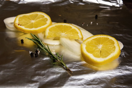 Ingredients for cooking fresh fish are on the foil.の写真素材