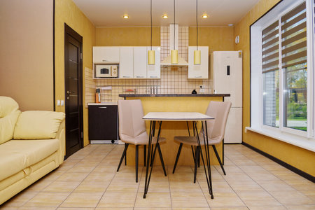 Interior of a modern comfortable kitchen. Beige shades, an island in the kitchenのeditorial素材