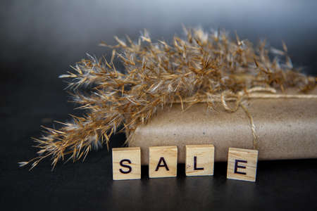 Shopping basket with gift box in waxed paper. The Concept Of Online Shopping. Christmas sales or gift shopping. Sale for New Year and Christmas. Buying gifts.の写真素材