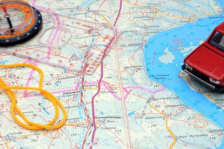 Sports liquid compass and model of the automobile on a fragment of a map