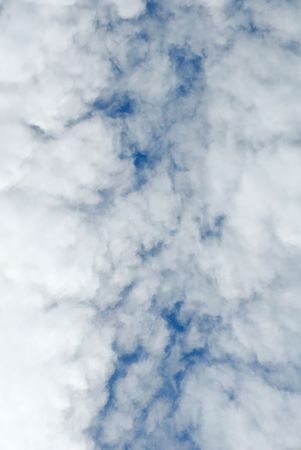 Cumulus white clouds in the dark blue sky
