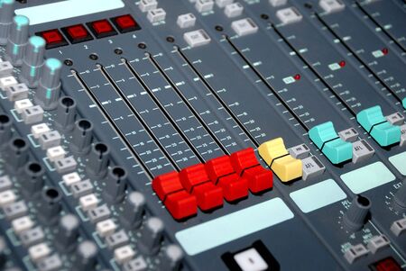 Audio mixing console in a recording studio. Faders and knobs of a sound mixer.