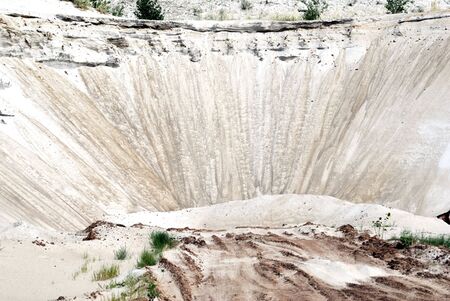 Slope of sandy mountain from white sandの写真素材