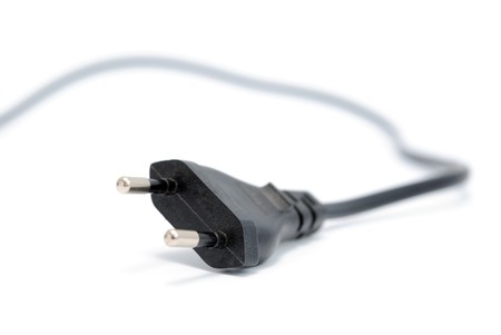 Black electrical plug and electrical cord isolated on white backgroundの写真素材