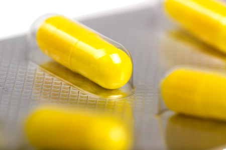 Medicine capsules packed in blisters isolated on white backgroundの写真素材