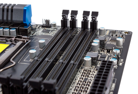 Electronics components on modern PC computer motherboard with RAM connector slot