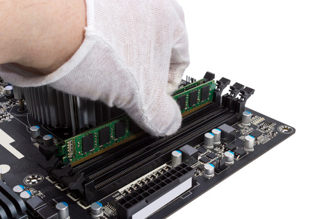 Installing memory module in DIMM slot on modern PC computer motherboardの写真素材