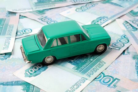 Toy car on the background of banknotes.の写真素材