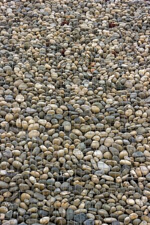Backgrounds collection - The decorative stone wall built of sea pebblesの写真素材