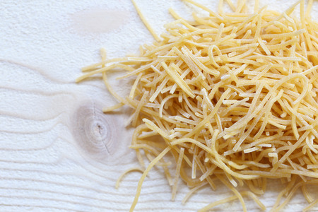 Homemade noodles on a white wooden board