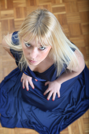 Beautiful woman in the blue dress on florの写真素材