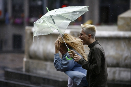 Belgrade, Serbia - Jun 30, 2014: People in the town during heavy rain. Walking with an umbrella on June in Belgrade, Serbia.のeditorial素材