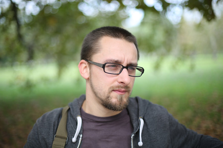 Portrait Of Man With Glasses Autumn Park on a day