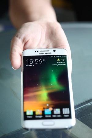 Belgrade, Serbia - May 16, 2015: Illustrative Mobile phone White Pearl  Samsung Galaxy 6 EDGE With curved glass and metal with 16 mp Camera.のeditorial素材