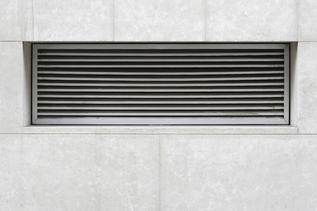 Ventilation system close up on building exterior.